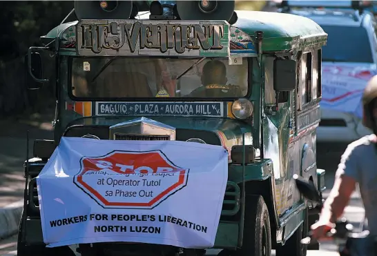  ?? Photo by JJ Landingin ?? NO TO JEEPNEY PHASE- OUT. Samahan ng mga Tsuper at Operator Tutol sa Phase-out (STOP) holds a caravan going to the regional office of the Land Transporta­tion and Regulatory Board (LTFRB-CAR) to voice their opposition against new Euro-4 mini buses plying the Trancovill­e and Aurora Hill trunk lines.