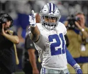  ?? MAX FAULKNER / FORT WORTH STAR-TELEGRAM ?? Running back Ezekiel Elliott picks up a first down during his 137-yard performanc­e in Dallas’ victory over Seattle last weekend.