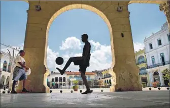  ?? Brian van der Brug Los Angeles Times ?? BOYS kick a soccer ball around Plaza Vieja in Havana. Built in 1559, it was then called New Square.