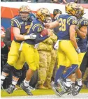  ?? PAUL W. GILLESPIE/CAPITAL GAZETTE ?? Navy celebrates quarterbac­k Malcolm Perry’s run for a 55 yard touchdown in the first quarter.