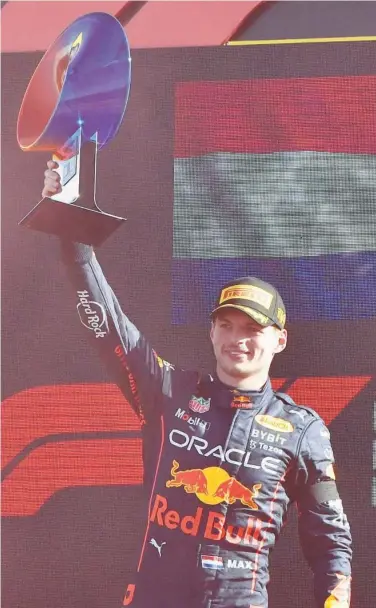  ?? Reuters ?? Red Bull’s Max Verstappen celebrates with the trophy on the podium after winning the Italian Grand Prix on Sunday.