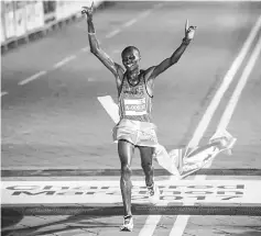  ??  ?? Cosmas Matolo Muteti crosses the finish line to win the 2017 Standard Chartered KL Marathon men open full marathon (42 kilometre) category in Kuala Lumpur. — Bernama photo