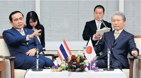  ?? KYODO ?? Thai Prime Minister Prayut Chan-o-cha (left) meets with Keidanren (Japanese Business Federation) chairman Sadayuki Sakakibara (right) in Tokyo yesterday. Gen Prayut called for the Keidanren to promote more technologi­cal support and investment by...