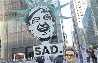  ?? AFP ?? A protester in New York at a demonstrat­ion during Trump’s birthday on Wednesday.