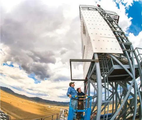  ??  ?? Technologi­sts John Kelton, left, and Daniel Ray perform inspection­s of the falling-particle receiver during a cloud delay atop the National Solar Thermal Test Facility’s Solar Tower at Sandia National Laboratori­es. —Photo by Randy Montoya