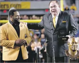  ?? Jared Wickerham Getty Images ?? DAVE BAKER, right, is president of the Pro Football Hall of Fame, a job that puts him in touch with enshrinees such as former Steelers great Jerome Bettis.