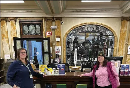  ?? PHOTO COURTESY OF DANIELLE SANZONE ?? Troy Public Library’s head of circulatio­n Virginia Wescott and Albany Chapter of ADK’s membership chair Danielle Sanzone bookend snowshoes donated to the library by ADK.