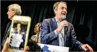  ?? CARLOS BERNATE / NEW YORK TIMES ?? Gov. Ralph Northam speaks to Democratic Party supporters as they celebrate winning control of the Virginia Legislatur­e at an election night gathering in Richmond on Tuesday night. Control of Virginia’s government fell to Democrats for the first time in decades.