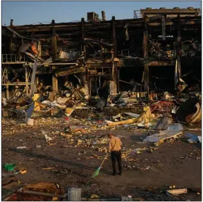  ?? (AP/Francisco Seco) ?? A man sweeps debris Friday outside a shopping and entertainm­ent mall destroyed by a Russian missile strike in Odesa, Ukraine.