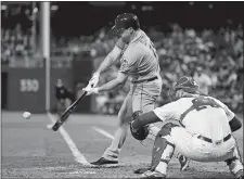  ?? MATT SLOCUM/AP PHOTO ?? New York’s Jay Bruce hits an RBI single Friday night off Philadelph­ia Phillies starter Alec Asher during the fourth inning of their game in Philadelph­ia. At right is catcher Cameron Rupp. The Mets won, 5-1.