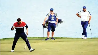  ?? — AFP photo ?? Cantlay celebrates as Shane Lowry of Ireland and team Europe looks on during the 43rd Ryder Cup at Whistling Straits in Kohler, Wisconsin.