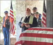  ??  ?? Bishop David Epps from the Cathedral of Christ the King in Sharpsburg leads the funeral service for Marine veteran Richard Lindsay Butterfiel­d on Wednesday morning at Georgia National Cemetery.