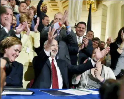  ??  ?? In this file photo, Pennsylvan­ia Gov. Tom Wolf cheers after signing a billat the Pennsylvan­ia State Capitol Rotunda in Harrisburg. The Legislatur­e is still trying to get its arms around the balooning public pension crisis. Some lawmakers ignored a push to get them out of traditiona­l defined benefit pension plans.