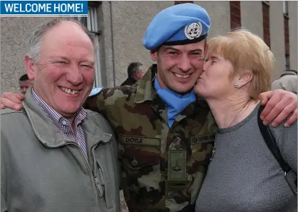  ??  ?? Airman William Doyle from Wicklow is greeted by his parents, Catherine and Andy, at Casement Aerodrome last Thursday when 100 Irish troops from the 55th Infantry Group, United Nations Disengagem­ent Observer Force (UNDOF) returned home following a...