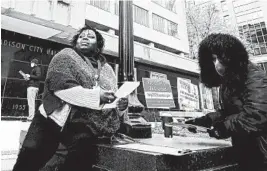  ?? JOHN HART/WISCONSIN STATE JOURNAL ?? Theola Carter, left, and Carrie Braxton fill out ballots Oct. 20 in Madison, Wisconsin. The Supreme Court has refused to extend the state’s deadline to receive and count ballots.