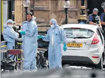  ?? AP PHOTO ?? Forensics officers work near the car that crashed into security barriers outside the Houses of Parliament in London, Tuesday.