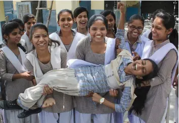  ?? — PTI ?? Students celebrate after the announceme­nt of Haryana Board Class 10 results in Gurgaon on Monday.