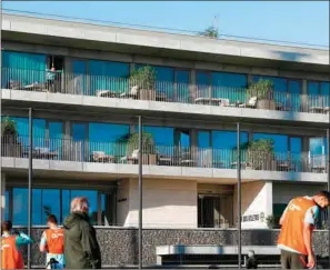  ?? (AFP) ?? This handout picture released on October 13, 2020 by the Portuguese Football Federation shows Portugal’s forward Cristiano Ronaldo (left, up) watching his teammates’ training session from a balcony at Portugal’s training camp in Oeiras, on the outskirts of Lisbon, on Tuesday.