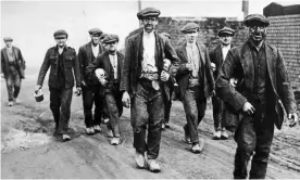  ??  ?? English coal miners walk home from work, circa 1925. Photograph: Hirz/Getty