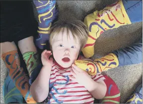  ??  ?? AWARENESS Four-year-old Ted Osborne, from Portsmouth, surrounded by funky socks. Left: Kezia Morgan at St Jude’s School which is supporting the event. Below, supporters’s pets joining the campaign and charity patron Emma Barton from EastEnders