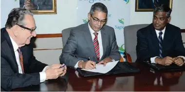  ?? CONTRIBUTE­D ?? President and CEO of Sagicor Group Jamaica Limited, Richard Byles ( centre), signs an agreement on Wednesday, January 29, to acquire RBC Royal Bank Jamaica and RBTT Securities Jamaica Limited. He is flanked by Sagicor Jamaica Chairman R. Danny Williams...