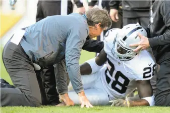  ?? Don Wright / Associated Press ?? The Raiders tend to running back Latavius Murray after he was injured with a concussion during Sunday’s game at Pittsburgh. Murray isn’t fully cleared to play yet.