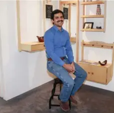  ?? ANDREW FRANCIS WALLACE/TORONTO STAR ?? Yusuf Mannan sits near his display, the Peg Project, which is made out of maple and birch wood using traditiona­l hand tools and no screws.