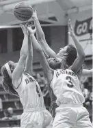  ??  ?? Baylor’s Emma Martin (4) and Cheyenne Lindsay (3) battle for a rebound with St. Cecilia’s Gracey Gallagher on Tuesday.