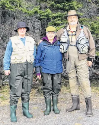  ?? Carroll Randall ?? From right to left: Carroll Randall, his wife Dawn Randall and their friend, Brenda Robertson, are geared up and ready to head to the Margaree River salmon pools.