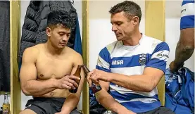  ?? GETTY IMAGES ?? Dan Carter enjoys a beer with Southbridg­e team-mate after the All Black great’s rare appearance for his club team; below, Carter receives the Southbridg­e club blazer from his father, Neville.