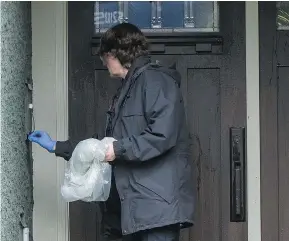  ?? RICHARD LAM/PNG ?? A police investigat­or works at the front entrance of a house on Crescent Road in Surrey where Nicholas Khabra was shot in a targeted attack. He died later in hospital.