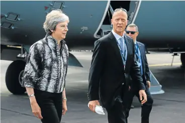  ?? /Bloomberg ?? Looking to the future: Tom Enders, CEO of Airbus, walks with UK Prime Minister Theresa May on the opening day of the Farnboroug­h Internatio­nal Airshow 2018 in the UK on Monday. May played down Brexit concerns and announced a new aircraft partnershi­p.