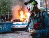  ?? ASHLEE REZIN GARCIA/SUN-TIMES FILE ?? Federal authoritie­s charged Timothy O’Donnell with setting fire to this Chicago police SUV on May 30 in the Loop while wearing a Joker mask.