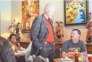  ?? MARLA BROSE/JOURNAL ?? During a campaign stop, former President Bill Clinton visits with Mike Brookshier at the Range Cafe in Bernalillo in May 2016.