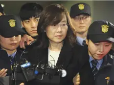  ??  ?? SEOUL: South Korea’s former culture minister, Cho Yoon-Sun (C), is escorted by police following her arrest. — AFP