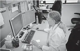  ?? [PHOTO PROVIDED] ?? Forensic DNA analyst Kelsey Lowther studies data for an investigat­ion.