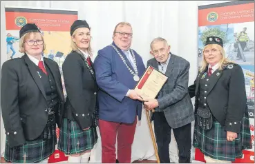  ?? (Pic: Brian Lougheed) ?? Fermoy Pipe Band stalwart, John Fant, accepting his certificat­e from Cllr. Danny Collins, the Mayor of the County of Cork, in recognitio­n of his nomination at the Mayor’s Awards, pictured in the company of members of Fermoy Pipe Band - Mary Caplice, Samantha Costigan and Noreen Doody - on Tuesday evening.