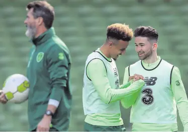  ??  ?? Back in business: Sean Maguire (far right) shares a joke with Callum Robinson in training