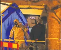  ?? AP PHOTO ?? Investigat­ors next to a police tent outside The Mill public house at the Maltings in Salisbury, England, Tuesday, March 6, 2018, near to where former Russian double agent Sergei Skripal was found critically ill.