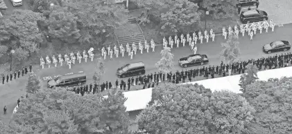  ?? KYODO NEWS VIA AP ?? The hearse, left, carrying the body of former Japanese Prime Minister Shinzo Abe leaves Zojoji temple after his funeral in Tokyo on Tuesday. Abe was assassinat­ed Friday while campaignin­g in Nara, western Japan.