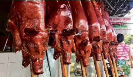  ?? PHOTOS BY JHESSET O. ENANO ?? The City Hall project initially covers 14 lechon stores, including one dating back to 1952 and currently run by Cora de los Reyes, 75 (lower left photo).—