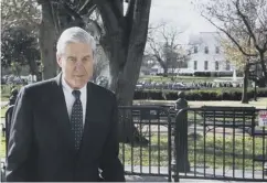  ??  ?? 0 Robert Mueller walks past the White House yesterday