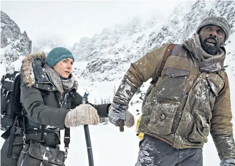  ??  ?? Heating up: Kate Winslet and Idris Elba’s characters warm towards each other on an icy trek to civilisati­on in The Mountain Between Us