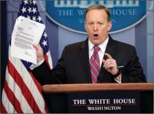  ?? The Associated Press ?? PRESS BRIEFING: White House press secretary Sean Spicer holds up a document concerning a Washington Post story on Sally Yates as he talks to the media during the daily press briefing Tuesday at the White House in Washington.