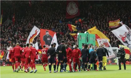  ?? Photograph: Carl Recine/Action Images via Reuters ?? The Liverpool and Bournemout­h players greet each other without shaking hands before their match on 7 March, the last Premier League game at Anfield in front of fans.