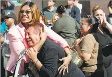  ?? Associated Press file photo ?? Two women hold each other as they watch the World Trade Center burn following a terrorist attack on the twin towers in New York on Sept. 11, 2001.