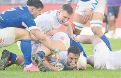  ?? Picture: AFP ?? OVER THE LINE. England’s scrumhalf Alex Mitchell scores a try during their Six Nations match against Italy at the Stadio Olimpico in Rome on Saturday.