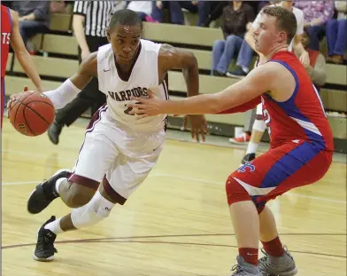  ?? Terrance Armstard/News-Times ?? To the basket: West Side Christian’s Stephfan Tabe (23) drives past Garrett Memorial Christian’s Devin Harris (12) during the first half of their contest in the AACS South District Tournament on Friday.