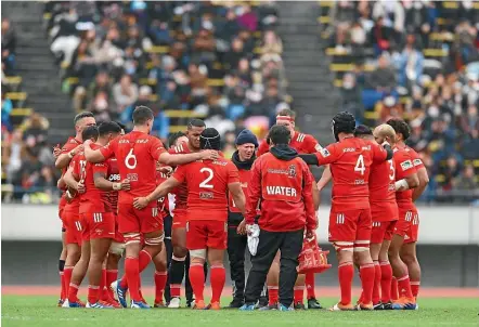  ??  ?? Manawatu¯ man Joe Rush, centre, works as a translator for the Kobelco Steelers rugby team in Japan.