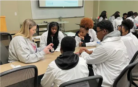  ?? (Special to The Commercial/Chris Carmody/University of Arkansas for Medical Sciences) ?? Students watch a demonstrat­ion showing how ear molds are made during the Pathways Academy College of Health Profession­s Day on Feb. 18 at the University of Arkansas for Medical Sciences at Little Rock.